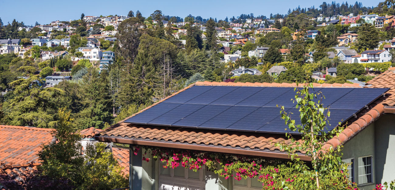 Solar panels on a clay tile roof in a neighborhood setting