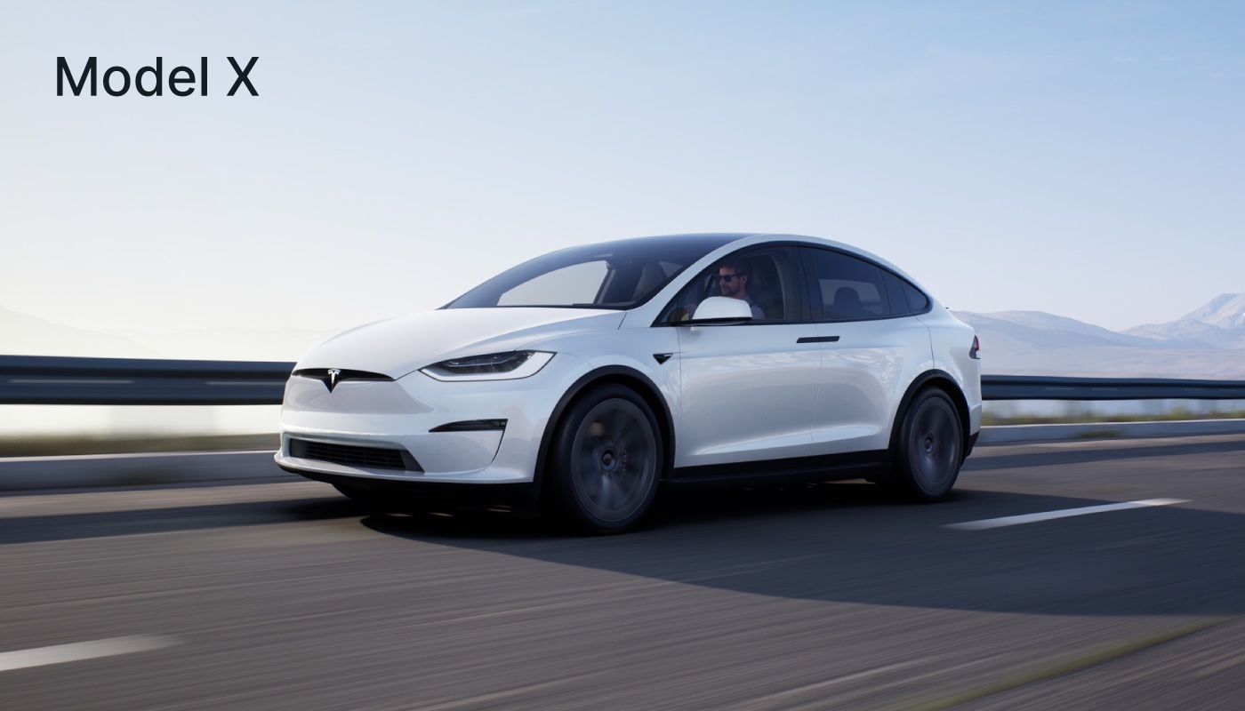 White Tesla Model X driving on a road