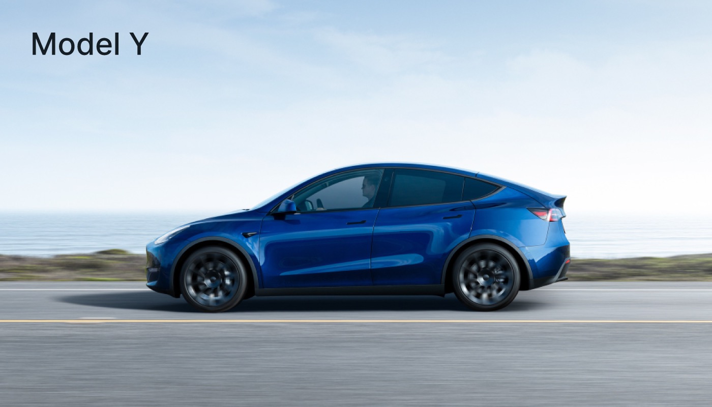 Blue Tesla Model Y driving on a road